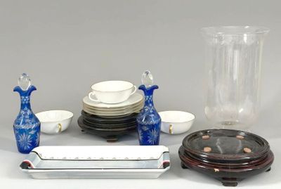 a table with a vase, plates, cups, and other items on it