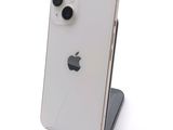 a white iphone sitting on top of a black stand