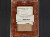 an old picture frame with a piece of paper taped to it
