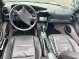 the interior of a car with leather seats and a steering wheel