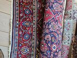 many rugs that are on display in a room