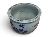 a blue and white bowl with a bird design on it