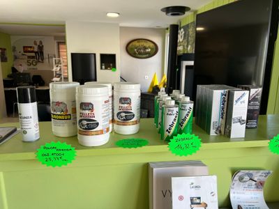 many cans of paint sitting on a counter in the kitchen