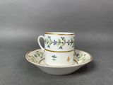 a close up of a cup and saucer on a table
