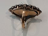 an image of a gold ring on a white surface with a string