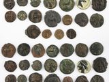 a collection of ancient roman coins on a white surface