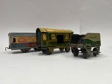 two toy trains sitting next to each other on a white surface