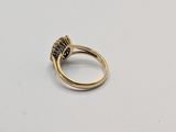 a close up of a gold ring with a blue stone in it