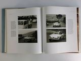 a book open on a table with pictures of cars on it