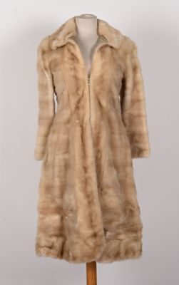 an image of a woman ' s fur coat on a mannequin stand