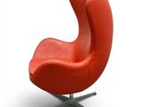 an image of a red chair with a metal base on a white background