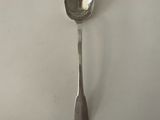 silver spoon on a white surface with a small spoon sticking out of it