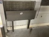 an image of a stainless steel grill in a garage