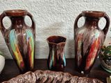 three vases sitting on a table next to each other