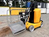 a yellow forklift with a yellow container on the back of it