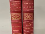 three red books with gold trims on them sitting on a white surface