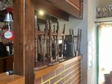 an image of a bar with a bunch of guns on the counter