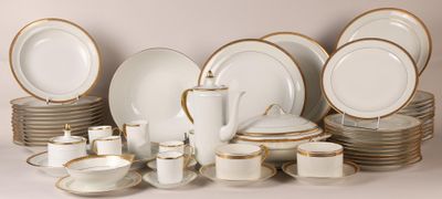 a lot of white and gold plates and cups