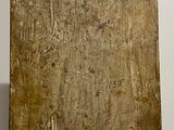 a piece of wood with writing on it in a room