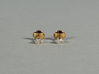 a pair of gold and diamond stud earrings