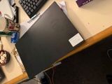 a laptop computer sitting on top of a desk next to a keyboard