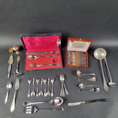 a box of silverware on a table next to a box of spoons
