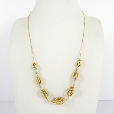 a gold necklace on a mannequin mannequin mannequin mannequin mannequin mannequin mannequin mannequin mannequin