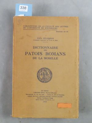 an old book sitting on top of a table next to a blue tag