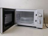 a microwave that is sitting on a counter with its door open