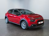 the red citrole is parked in a large room