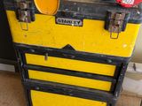 a yellow tool box with tools on top of it