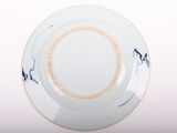 a white plate with blue designs on it on a white surface