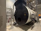 a large black and white boiler in a building