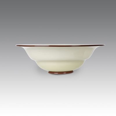 a close up of a white bowl with a brown rim