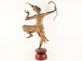 statue of a man holding a bow and arrow on a wooden base