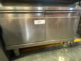 a stainless steel oven sitting on a cart in a kitchen