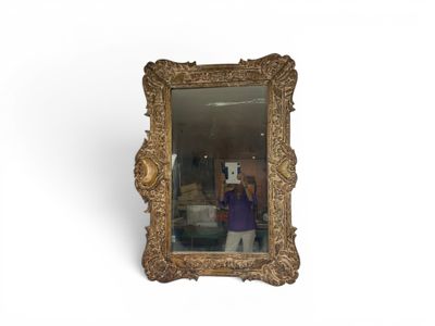 a woman taking a picture of herself in a mirror