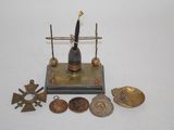 a small metal object with a clock on top of it
