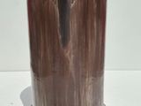a silver vase with a marble base on a white surface