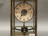 a gold clock that is sitting on a table