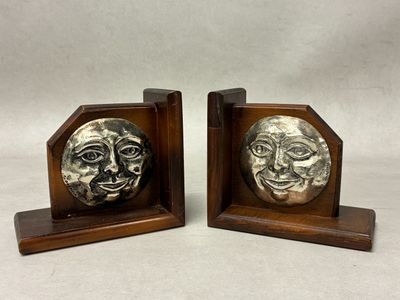 a pair of bookends with a face on each of them