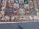 a rug on the floor with a pair of shoes on it