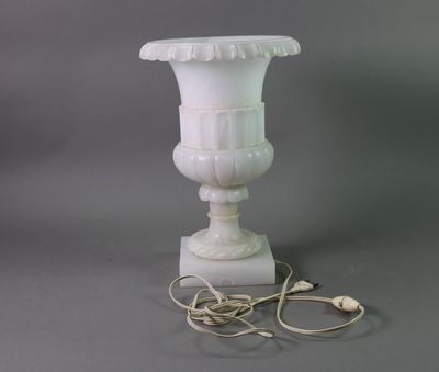 a white vase that is sitting on a table