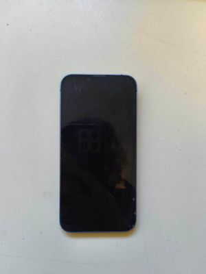un téléphone portable noir posé sur une table blanche