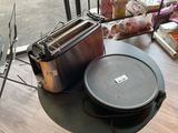 a toaster and a toaster sitting on a table in front of a window