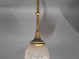 an antique brass ceiling light with a frosted glass shade