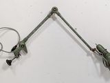 pair of green industrial style desk lamps on a white wall