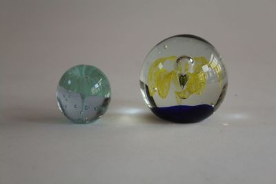 two glass marbles sitting next to each other on a table