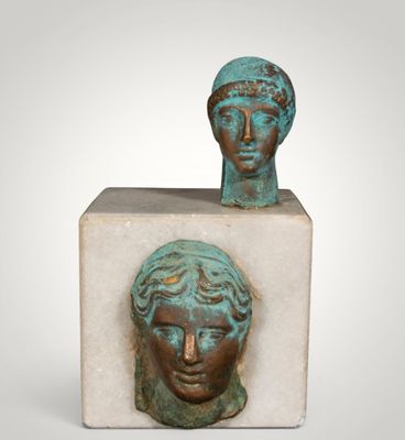 a close up of a sculpture of a head on a block
