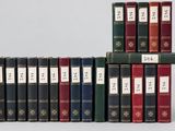 several books are stacked on top of each other on a table